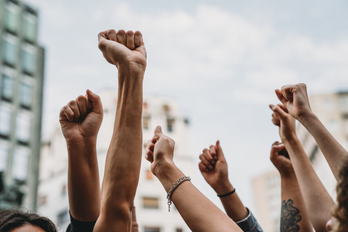 People with raised fists at a demonstration in the city